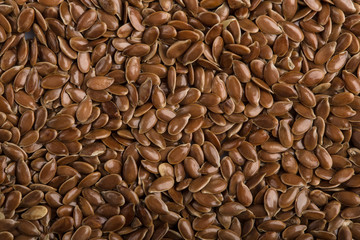 close up of flax seeds isolated on white background. Bowl full of brown flaxseed or linseed. Cereals. Vitamins. Healthy food.