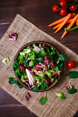Provence salad. Leaves of endive or chicory, lamb and rose salad. Cherry tomatoes and carrot. Raw...