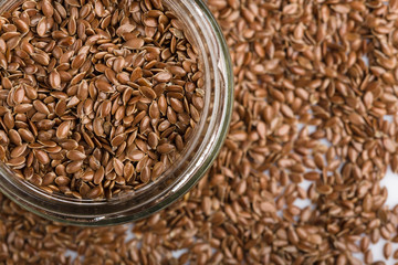 close up of flax seeds isolated on white background. Bowl full of brown flaxseed or linseed. Cereals. Vitamins. Healthy food.