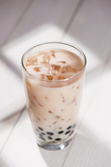 Boba / Bubble tea. Homemade Milk Tea with Pearls on wooden table.