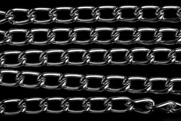 Chain heap - abstract metal background. Collection silver jewelry chains on an isolated black...