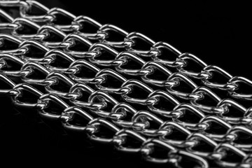 Chain heap - abstract metal background. Collection silver jewelry chains on an isolated black...