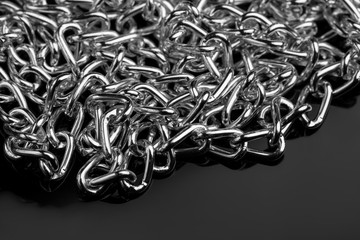 Chain heap - abstract metal background. Collection silver jewelry chains on an isolated black...
