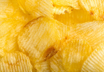 Crispy potato chips. Fast Food. Potatoes. Fatty unhealthy foods. corrugated chips