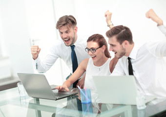 Picture of happy business team celebrating victory in office