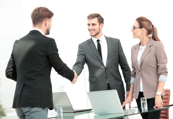 Fototapeta premium Handshake between business people in a modern office