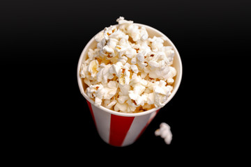 Popcorn in red and white cardboard box. Popcorn border isolated on white. Film. Fast food. Corn