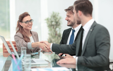 Handshake between business people in a modern office