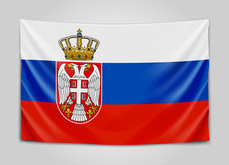 Fototapeta premium Hanging flag of Serbia. Republic of Serbia. National flag concept.