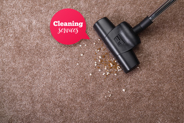 Vacuuming carpet with vacuum cleaner. Dirt on the rug. Housework service. Close up of the head of a...