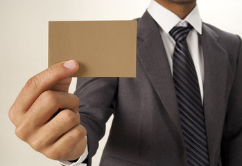 Business man holding business card and blurred focus background