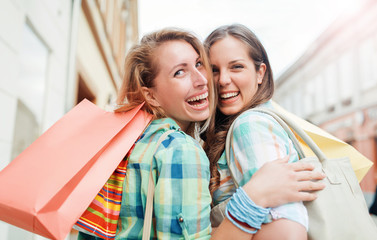 Shopping time. Young women shopping together. Consumerism, shopping, lifestyle