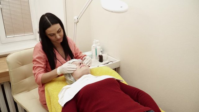 Beautician is making a precedure in salon