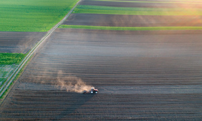 Tractor harrowing soil