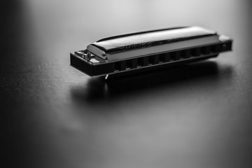 Harmonica isolated on black background. Black and white photography.