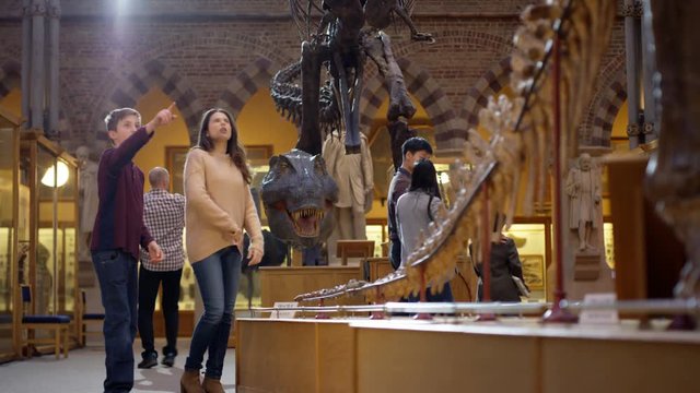  Mother & son in natural history museum looking at the exhibits with amazement