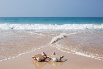 Fototapeta na wymiar two girls relaxing on the beach
