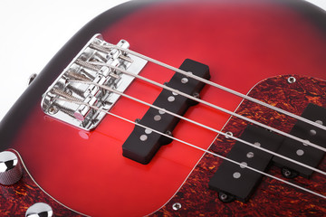 Metallic volume treble guitar bass knobs. Electric guitar. Red electric bass guitar close-up....