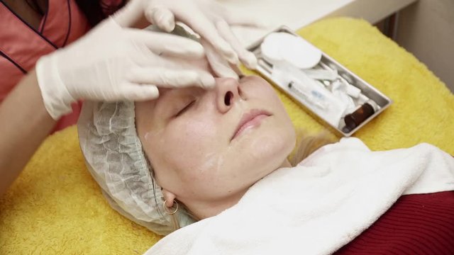 Beautician preparing woman for the therapy in beauty salon
