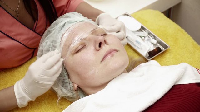 Beautician preparing woman for the therapy in salon closeup