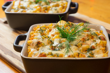 Macaroni or pasta with cheese and meat in square dish. Warm dish from the owen. Close up / macro...
