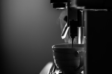 Close-up of espresso pouring from coffee machine. Professional coffee machine. Office. 