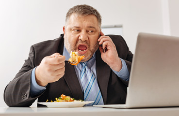 Hungry tired company employee overloaded with work
