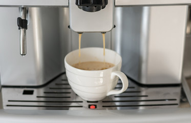 Close-up of espresso pouring from coffee machine. Professional coffee machine. Office. 