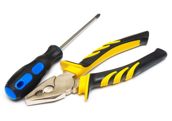 Screwdriver and pliers isolated on white background. Flat lay, top view