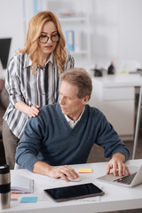 Fototapeta premium Young businesswoman distracting colleague in the office