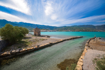 Obraz premium Old windmills with canal near famous summer resort Elounda, Eastern Crete, Greece