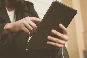 Man using tablet outdoor.