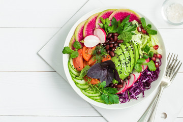 vegan lunch bowl. Avocado, red bean, tomato, cucumber, red cabbage  and watermelon radish  vegetables salad. healhty food