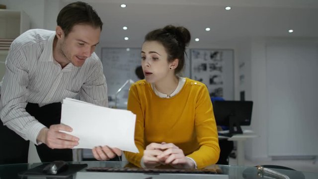  Young woman making video call in office is interrupted by annoying colleague