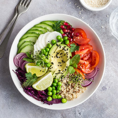 healhty vegan lunch bowl. Avocado, quinoa, tomato, cucumber, red cabbage, green peas and radish  vegetables salad.
