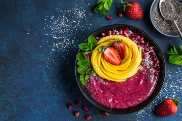 delicious blueberry smoothie bowl with mango and strawberry