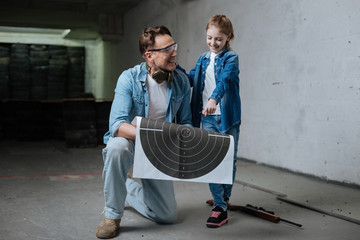 Happy delighted man holding the target