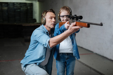 Happy delighted girl looking into the optical sight