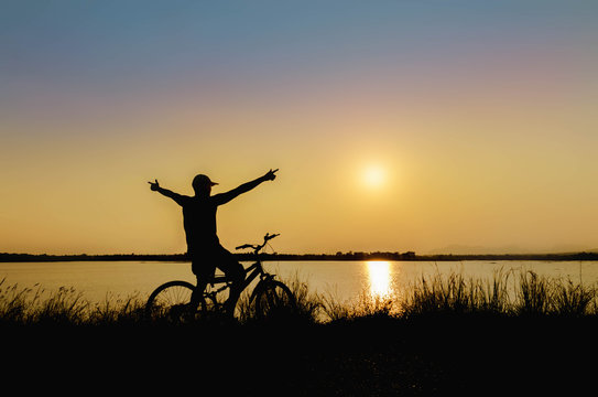 silhouette of cyclist in nature background and beautiful sunset