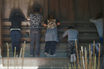 unidentified peoples pray in a temple in Ho Chi Minh City, Vietnam. A significant number of religions co-exist in Vietnam for centuries.