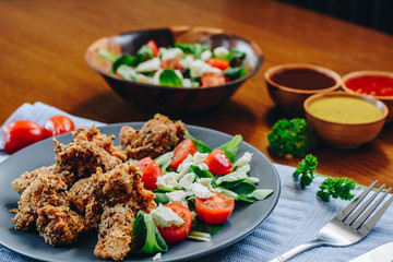 Chicken nuggets with fresh salad and sauces