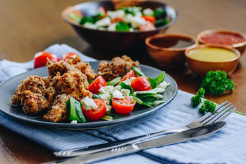 Chicken nuggets with fresh salad and sauces