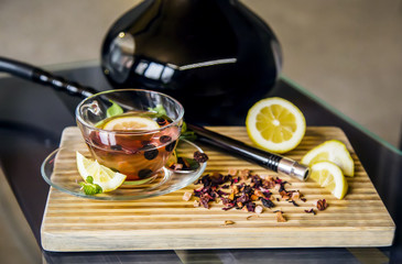 Hookah and tea ceremony on wood with lemon and mint