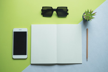 Flat lay of minimal workspace desk with smartphone