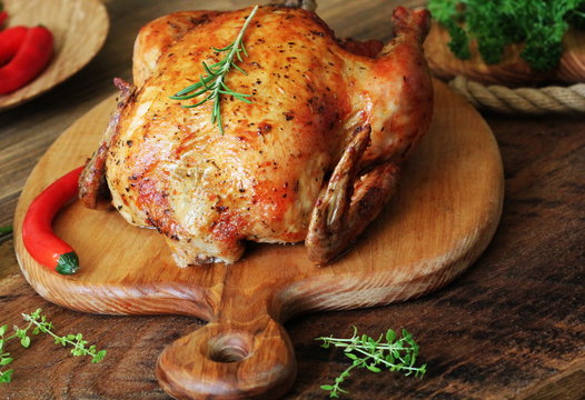 Whole roasted chicken on cutting board