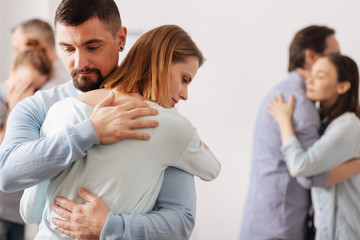 Brave male person embracing his coworker