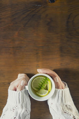 Cup of tea with thyme herb and lemon slices