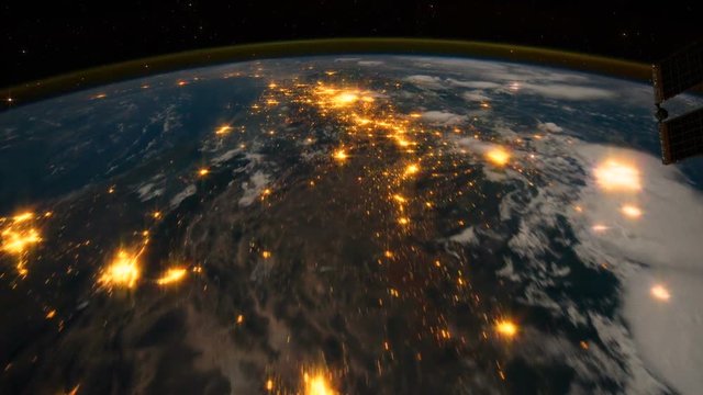 International Space Station (ISS) shot showing an orbit over Southern Canada with city lights and lightning bolts. Video treatment from source stills courtesy of NASA.
