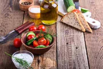Fototapeta na wymiar Salad of fresh tomato, cucumber and olive oil