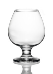 Glass of brandy or whiskey on white background